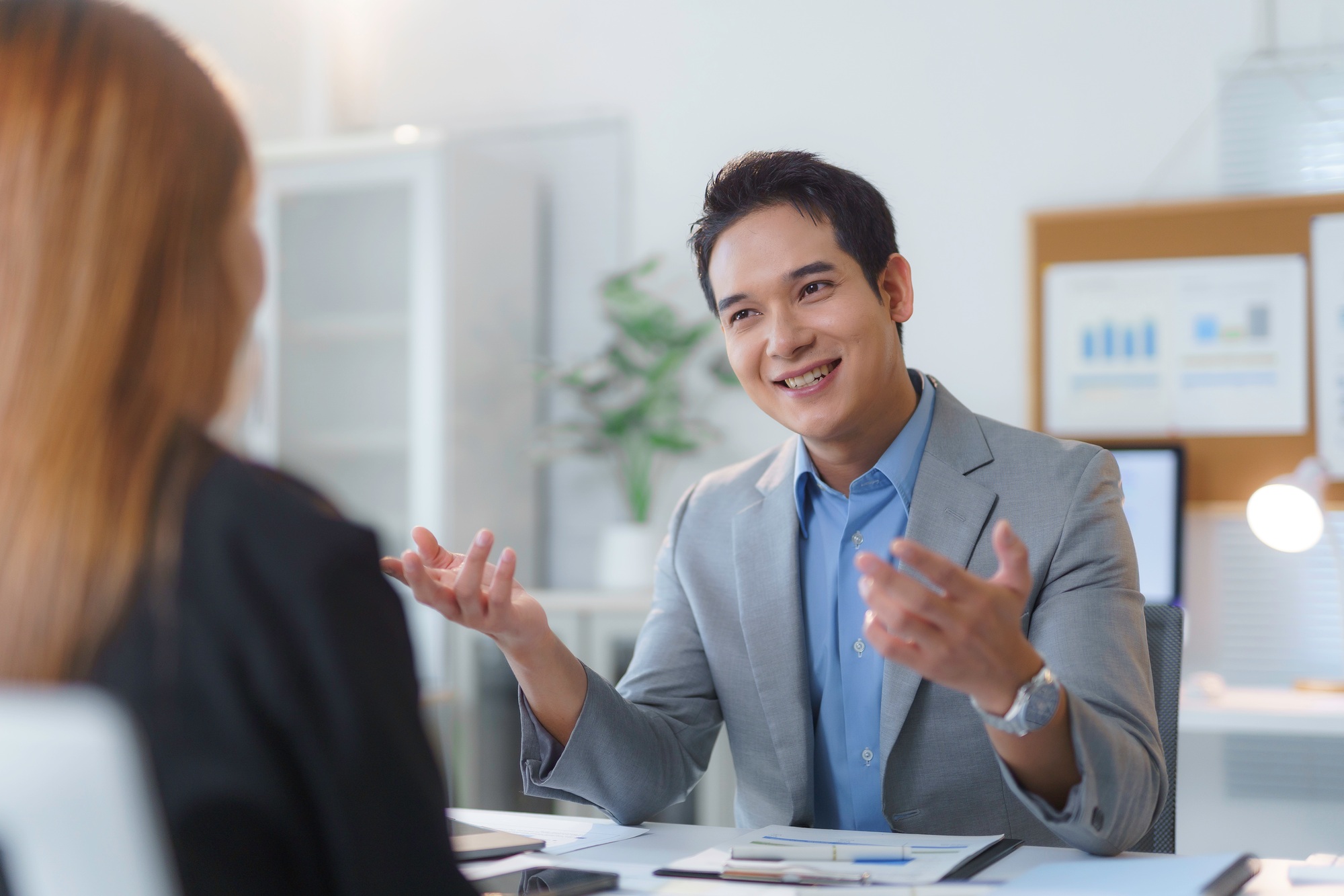 Asian businessman explaining something during a meeting with a female colleague