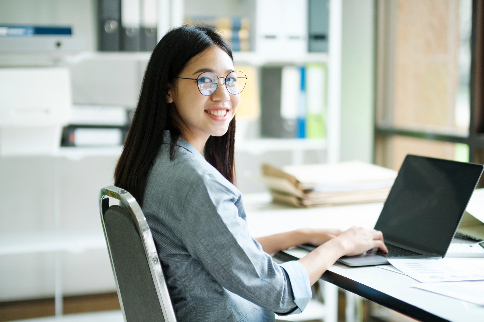 Young asian business woman or student working online on computer laptop.